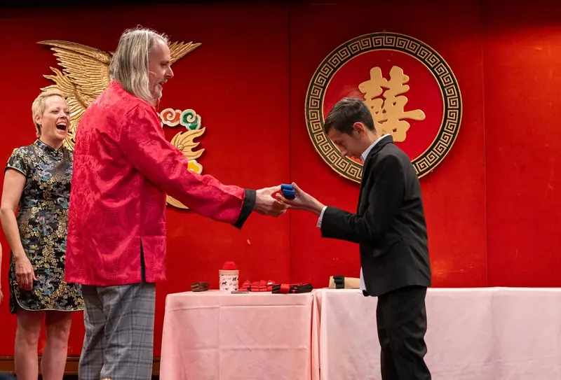 Master David Starks presenting a belt to a Kung Fu student