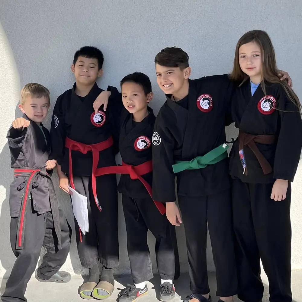 Kids Kung Fu students proudly showing their belts